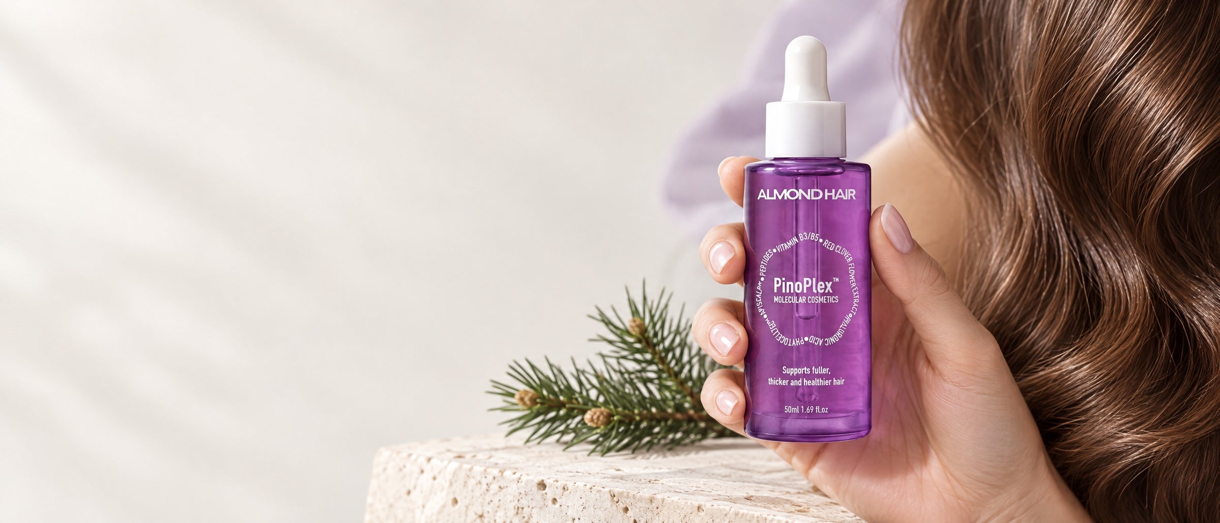 Almond Hair PinoPlex serum beside long brown hair